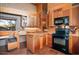 This eat-in kitchen features wooden cabinetry, brick floors, and black appliances at 25232 N Horseshoe Trl, Scottsdale, AZ 85255