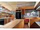This kitchen has a black refrigerator, wooden cabinetry and a nook for eating at 25232 N Horseshoe Trl, Scottsdale, AZ 85255