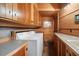 Laundry room with ample cabinet space and tile flooring at 25232 N Horseshoe Trl, Scottsdale, AZ 85255