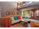This living room features a couch that wraps around the room and brick floors at 25232 N Horseshoe Trl, Scottsdale, AZ 85255