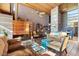 Cozy living room with a copper fireplace, tall ceilings and brick accents, creating an inviting atmosphere at 25232 N Horseshoe Trl, Scottsdale, AZ 85255