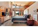 This main bedroom leads to the pool and features brick accents, a fan and wood paneling at 25232 N Horseshoe Trl, Scottsdale, AZ 85255