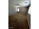 Neutral bedroom featuring a window and neutral color scheme with neutral brown carpeting at 25862 W North Star Pl, Buckeye, AZ 85326