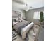 Comfortable bedroom featuring a queen-sized bed, natural light, and stylish accents at 25862 W North Star Pl, Buckeye, AZ 85326