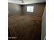 Bedroom featuring a window and neutral color scheme with neutral brown carpeting at 25862 W North Star Pl, Buckeye, AZ 85326