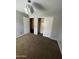 Bedroom with an open closet and entry, and neutral brown carpeting at 25862 W North Star Pl, Buckeye, AZ 85326