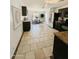 Well-lit kitchen featuring tile floors and modern appliances that flows into the dining area at 25862 W North Star Pl, Buckeye, AZ 85326