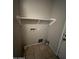 Laundry room features tile flooring, shelving and washer/dryer hookups at 25862 W North Star Pl, Buckeye, AZ 85326