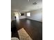 Spacious living room featuring dark hardwood flooring and neutral paint at 25862 W North Star Pl, Buckeye, AZ 85326