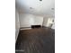 Bright living room with dark floors, recessed lighting, and open floor plan at 25862 W North Star Pl, Buckeye, AZ 85326