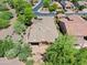 An aerial view of a home with a tile roof, lush landscaping, and a backyard patio in a residential neighborhood at 27581 N 129Th Ln, Peoria, AZ 85383