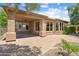 View of backyard with covered patio, desert landscaping and brick pavers at 27581 N 129Th Ln, Peoria, AZ 85383