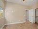 Bedroom showcasing tile flooring, a window, a closet with sliding doors and neutral walls at 27581 N 129Th Ln, Peoria, AZ 85383