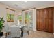 Cozy breakfast nook with table, chairs, natural light, backyard views and cabinet storage at 27581 N 129Th Ln, Peoria, AZ 85383