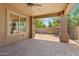 Covered patio with ceiling fan overlooking brick pavers and desert landscaping at 27581 N 129Th Ln, Peoria, AZ 85383