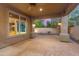 View of covered patio at dusk overlooking desert landscaping and brick pavers at 27581 N 129Th Ln, Peoria, AZ 85383