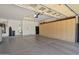 Spacious garage with ample storage cabinets and shelving along the back wall at 27581 N 129Th Ln, Peoria, AZ 85383