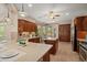 Stylish kitchen with granite counters, wood cabinets, stainless appliances, breakfast nook, and island at 27581 N 129Th Ln, Peoria, AZ 85383