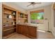 Home office with custom built-ins, a large window, and ample natural light at 27581 N 129Th Ln, Peoria, AZ 85383