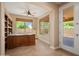 Inviting office with custom cabinetry, a window with backyard views, and tile floors at 27581 N 129Th Ln, Peoria, AZ 85383