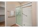 A shower with accessible grab bars, a glass sliding door, and a mounted shower head at 27581 N 129Th Ln, Peoria, AZ 85383