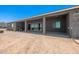View of the house's backyard, showing the back porch and a large dirt area at 30639 N Dorado Ct, Queen Creek, AZ 85144