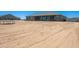 Spacious backyard featuring a home, a garage/shed, and a large dirt area at 30639 N Dorado Ct, Queen Creek, AZ 85144