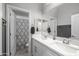 Modern bathroom boasting double sinks, white cabinets, large mirror, and tile floors at 30639 N Dorado Ct, Queen Creek, AZ 85144
