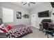 Teen bedroom with sports decor, a ceiling fan, carpet, and gaming desk at 30639 N Dorado Ct, Queen Creek, AZ 85144