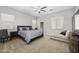 Spacious main bedroom featuring a ceiling fan, carpet floors, and ensuite bathroom at 30639 N Dorado Ct, Queen Creek, AZ 85144