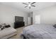 Bright bedroom showcasing a ceiling fan, lounge chair, and ensuite bathroom at 30639 N Dorado Ct, Queen Creek, AZ 85144