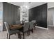 Dining room features a wooden table, upholstered chairs, modern chandelier, and wainscoting accent wall at 30639 N Dorado Ct, Queen Creek, AZ 85144