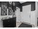 Elegant foyer featuring dark accents, a decorative mirror, and a glimpse of the home's interior at 30639 N Dorado Ct, Queen Creek, AZ 85144
