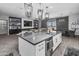 Open kitchen boasts a large center island, pendant lighting, and seamless flow into the living and dining areas at 30639 N Dorado Ct, Queen Creek, AZ 85144