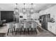 Open-concept kitchen with white cabinets, stainless appliances, and a large island with bar seating at 30639 N Dorado Ct, Queen Creek, AZ 85144