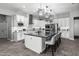 Bright kitchen featuring white cabinetry, stainless steel appliances, and an expansive center island with barstool seating at 30639 N Dorado Ct, Queen Creek, AZ 85144