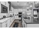 Bright kitchen featuring white cabinets, stainless steel appliances, and a herringbone backsplash design at 30639 N Dorado Ct, Queen Creek, AZ 85144