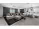 Open-concept living space showcases a modern kitchen, dining area, and a comfortable lounge with a large sectional sofa at 30639 N Dorado Ct, Queen Creek, AZ 85144