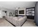 Open living room featuring built in shelves, fireplace and a large comfortable sectional sofa at 30639 N Dorado Ct, Queen Creek, AZ 85144