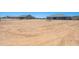 Large dirt lot with houses and garages/sheds in the distance at 30639 N Dorado Ct, Queen Creek, AZ 85144