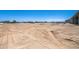 Large dirt lot with a home and trailer in the distance at 30639 N Dorado Ct, Queen Creek, AZ 85144