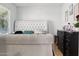 Bright bedroom featuring a large tufted headboard, and neutral color palette at 3107 N 79Th Ave, Phoenix, AZ 85033