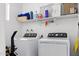 Functional laundry room with washer, dryer, shelving, and ample storage space at 3107 N 79Th Ave, Phoenix, AZ 85033