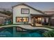 Inviting backyard with a covered patio, pool, and well-manicured lawn, perfect for outdoor entertaining at 3466 E Bruce Ave, Gilbert, AZ 85234