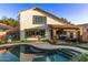 Charming backyard boasts a sparkling pool, lush artificial turf, and a covered patio for relaxing at 3466 E Bruce Ave, Gilbert, AZ 85234