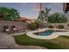 Private backyard showcasing a custom pool, lush landscaping, and comfortable lounge chairs at 3466 E Bruce Ave, Gilbert, AZ 85234