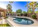 Serene backyard featuring a freeform pool, lush landscaping, and cozy outdoor seating at 3466 E Bruce Ave, Gilbert, AZ 85234