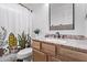 This bathroom features an updated vanity, granite countertop, and decorative shower curtain at 3466 E Bruce Ave, Gilbert, AZ 85234