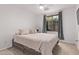 This bright bedroom offers a ceiling fan and large window for natural light at 3466 E Bruce Ave, Gilbert, AZ 85234