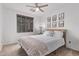 This bedroom offers a ceiling fan, natural light, and cactus-themed wall art at 3466 E Bruce Ave, Gilbert, AZ 85234